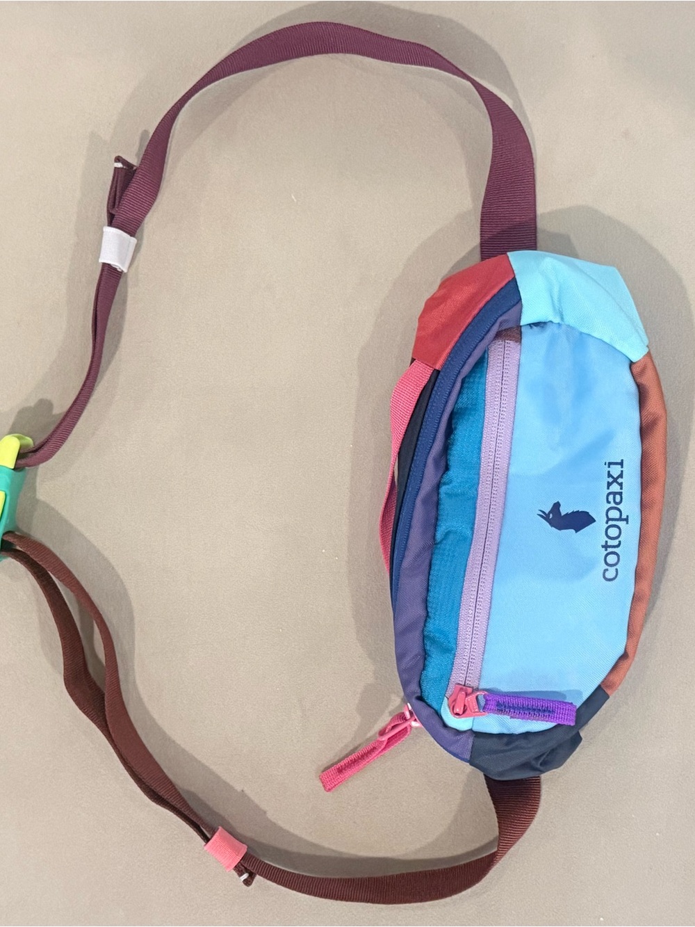 cotopaxi colorful waist pack with light blue front
